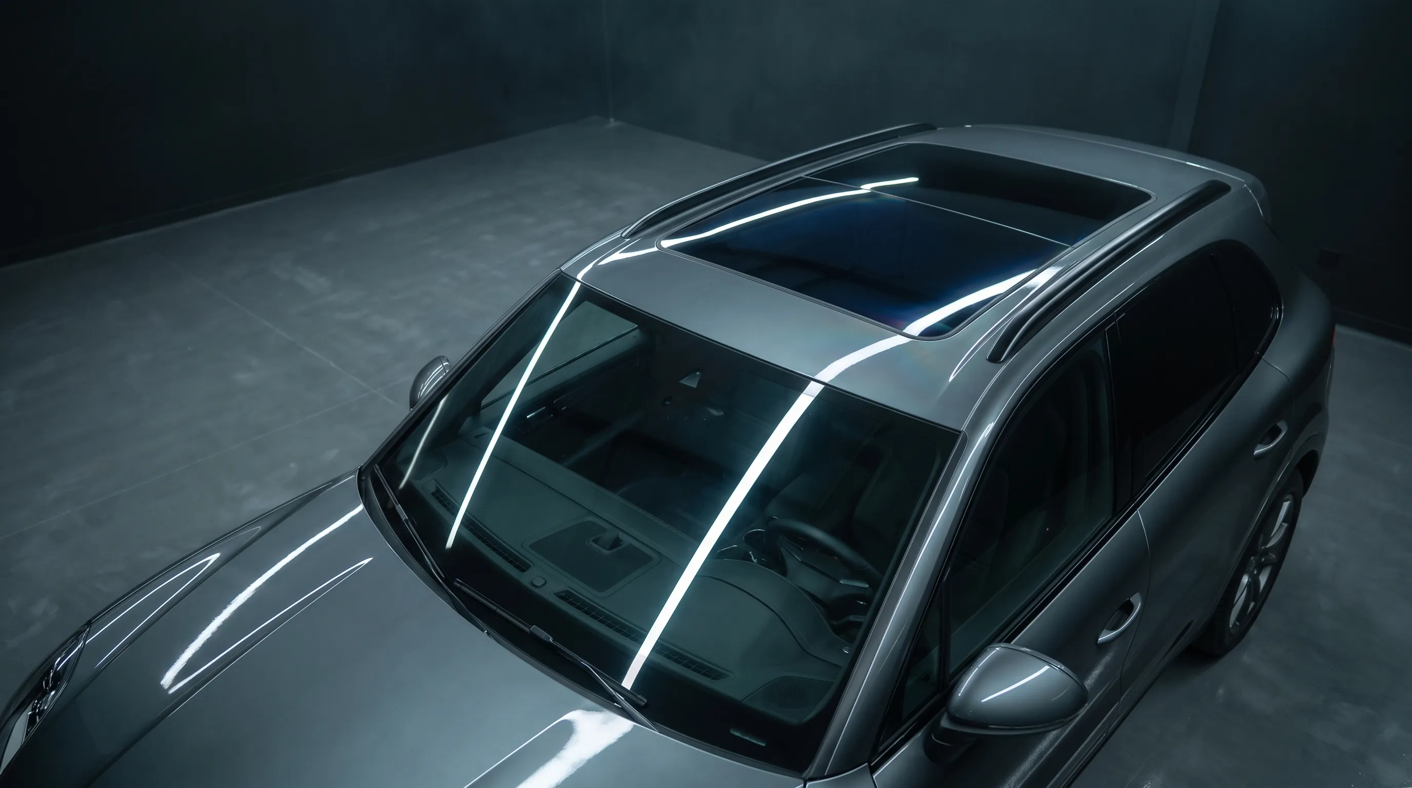 Overhead view of an SUV roof with dark heat-reduction film on the sunroof.